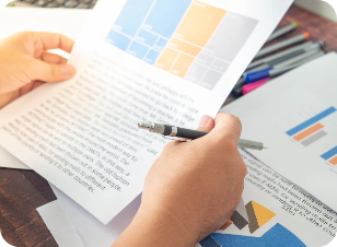 midsection-man-reading-book-table
